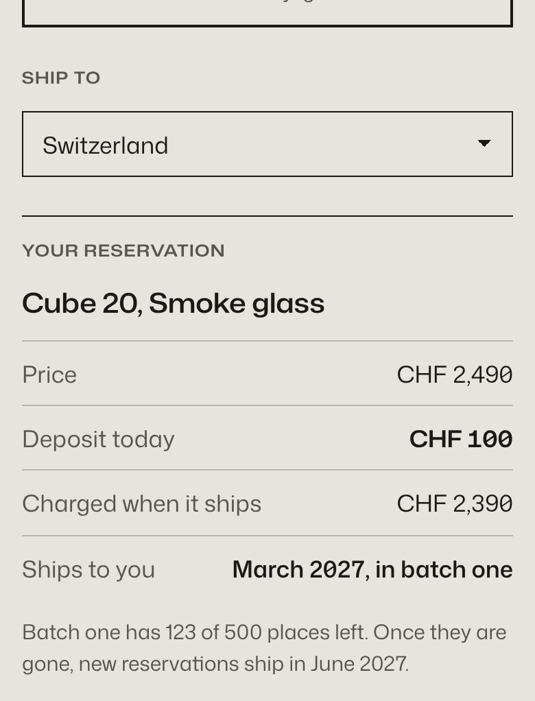 Exhibit A on a phone: a Ship to dropdown set to Switzerland, then the reservation summary with price, deposit today, charged when it ships, Ships to you March 2027 in batch one, and the line Batch one has 123 of 500 places left.